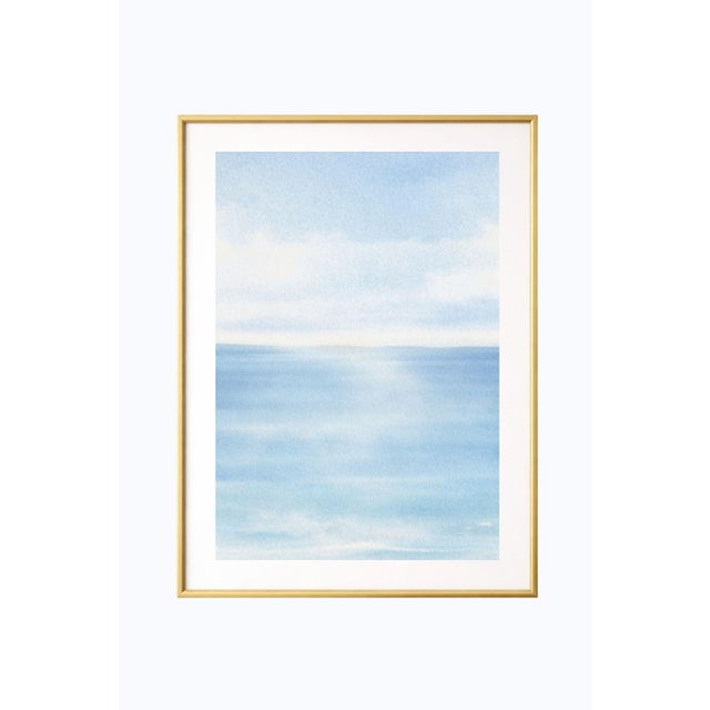 Minimalist coastal artwork featuring a soft ocean horizon with layered blue tones and gentle atmospheric haze. Subtle...