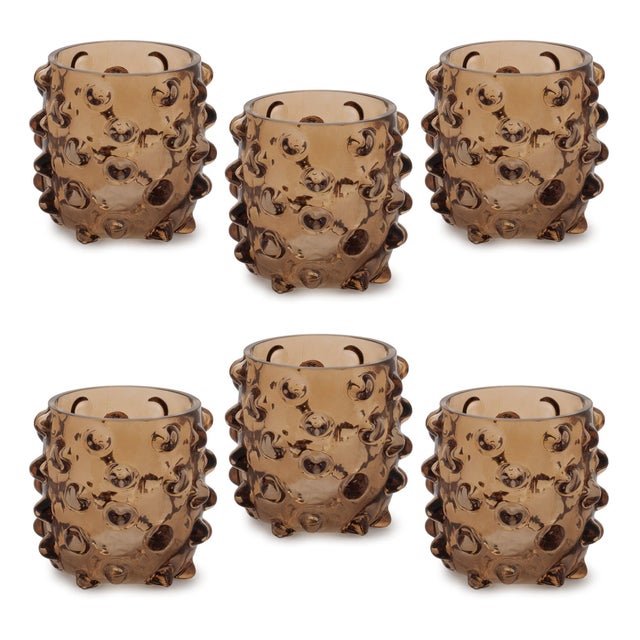 Add a touch of warmth and texture to your home with the Textured Glass Candle Holder Set. Featuring warm brown tones and a...