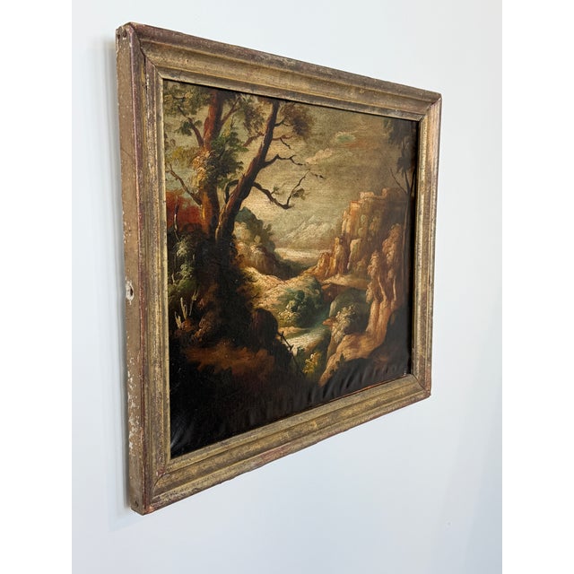 An atmospheric Old Master style Italianate landscape, oil on canvas, depicting a dramatic wooded river valley with rocky...