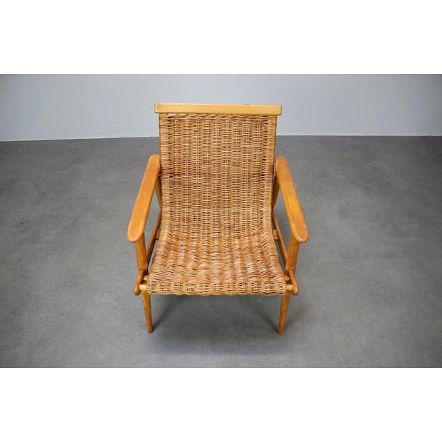 A beautiful vintage rattan armchair produced by ULUV in Czechoslovakia during the 1960s. This Mid-Century Modern lounge...
