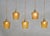 Set of five amber-coloured bubble glass pendant lights from mid-century France. Stylish and versatile these pendant lights...