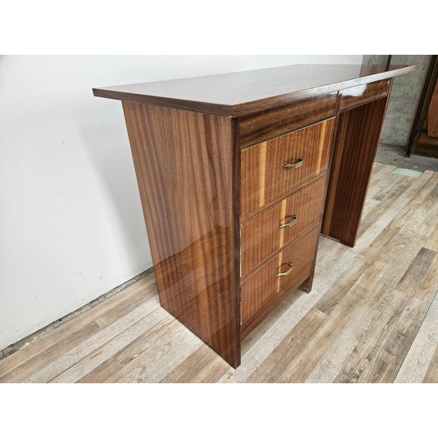 A charming small desk dating back to the 1960s, featuring a simple and functional design, typical of Italian home...