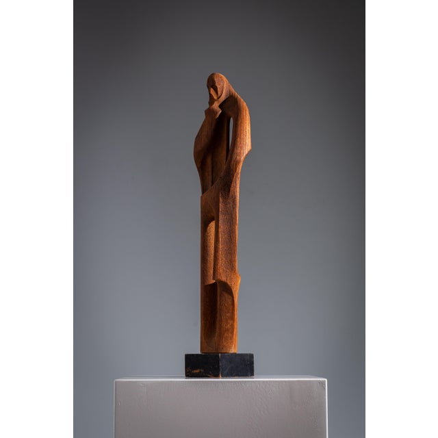 Add a touch of timeless elegance to your interior with this unique hand-carved wooden sculpture from the Art Deco period....