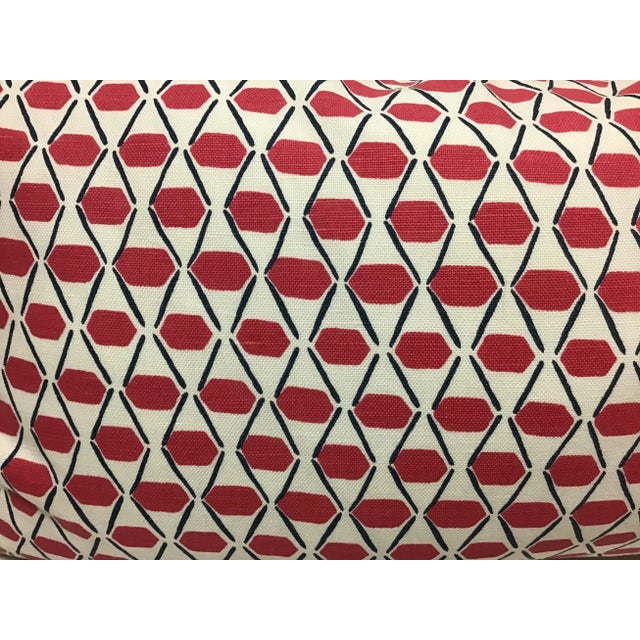 This lumbar pillow in Denver geometric print from Thibaut is bright pink and navy blue with a navy blue welt.