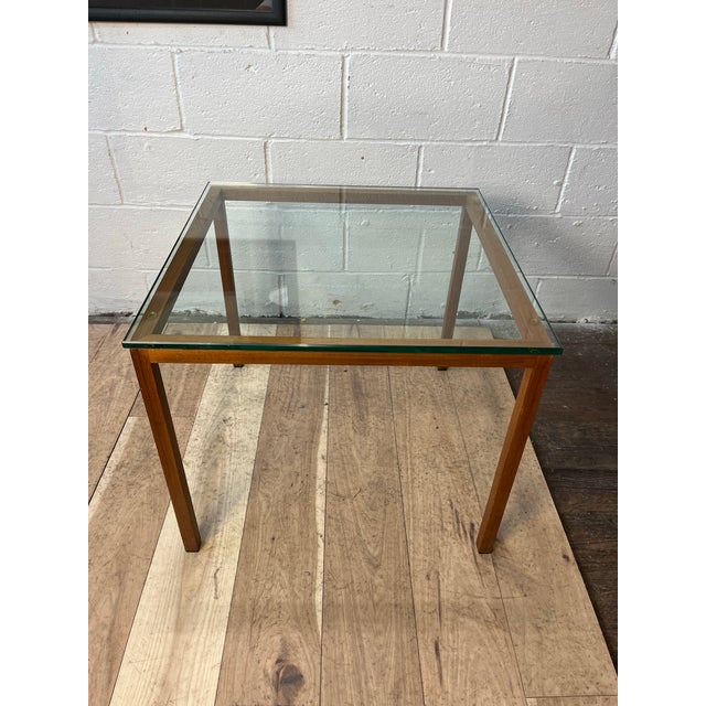 A sophisticated Postmodern side table featuring a textured faux bois metal frame finished to simulate walnut, supporting a...