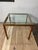 A sophisticated Postmodern side table featuring a textured faux bois metal frame finished to simulate walnut, supporting a...