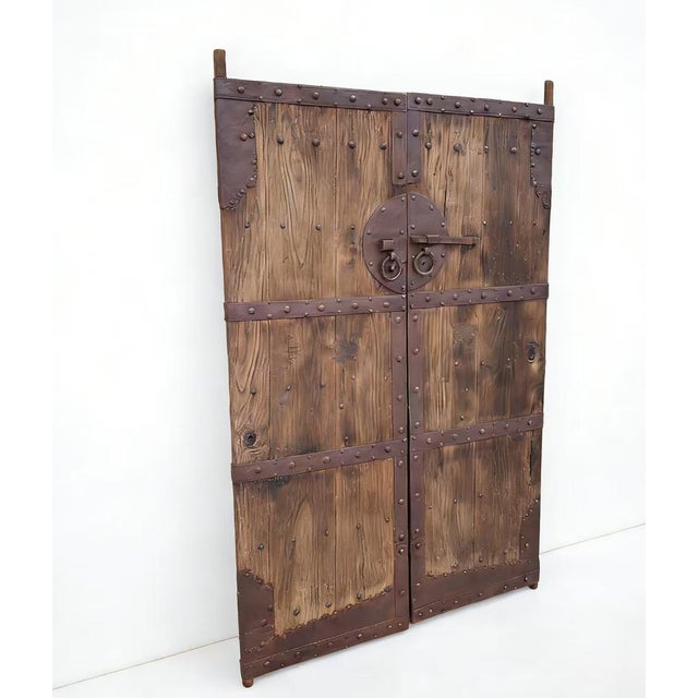 This pair of antique Chinese door panels&nbsp;showcases a blend of traditional craftsmanship&nbsp;through its rustic wood...