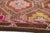 This is a vintage Turkish Oushak rug from the Mid 20th Century. The piece was hand-knotted.