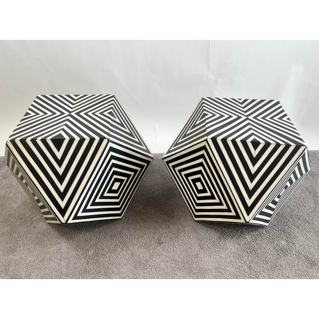 A striking pair of sculptural side tables embodies the bold geometric elegance of Art Deco design, seamlessly fused with a...