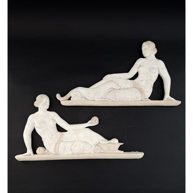 Pair of stucco bas-reliefs depicting female figures from the early 20th century. Italy. The upper sculpture depicts a...