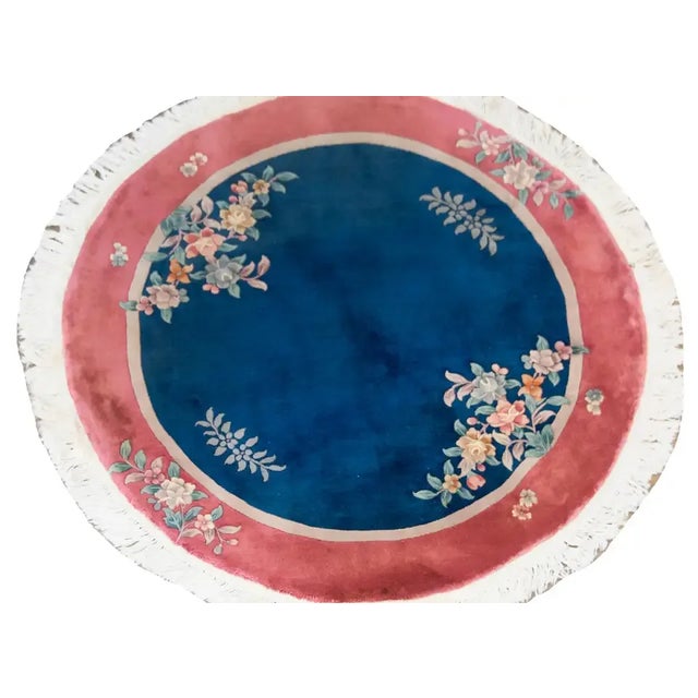 A beautiful early 20th century Chinese Art Deco round rug with a dark indigo field surrounded by a thin taupe stripe and...