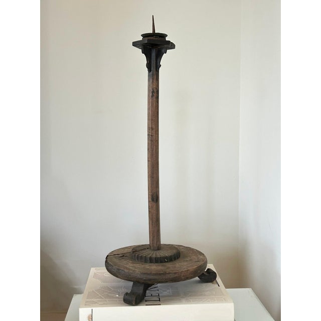 Primitive, antique wood candlestick with tripod-footed base. Unique details include dramatic height, hexagonal drip pan,...