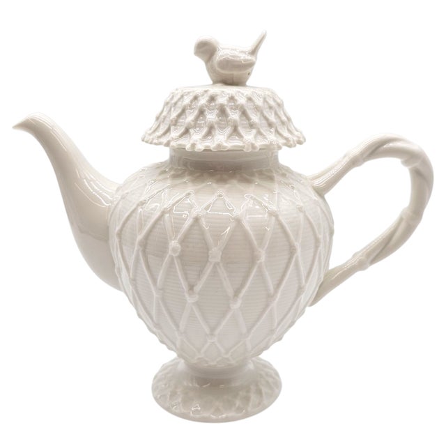 An ode to gentle mornings and porcelain ritual, this laced ceramic teapot glows softly in warm light. With a bird perched...