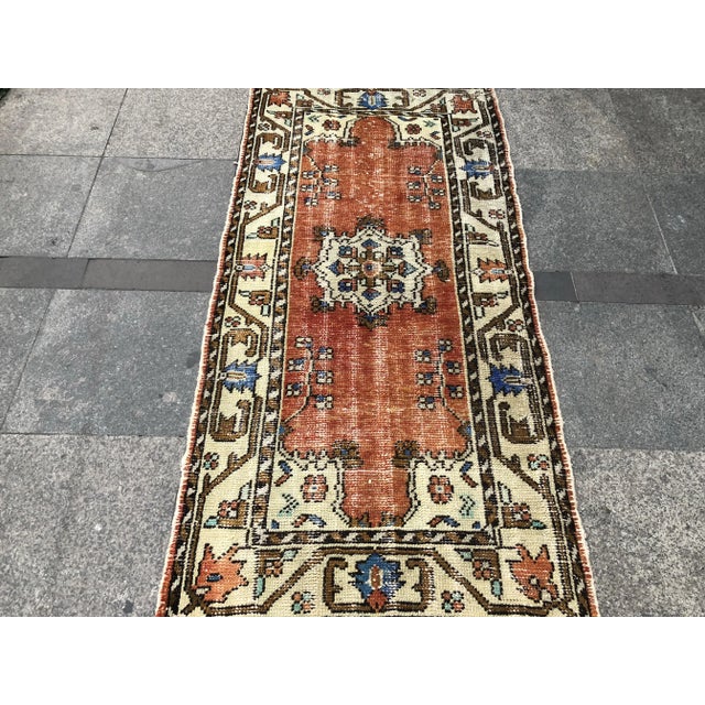 This is a vintage Turkish Oushak rug from the 1960s. The piece was hand-knotted.