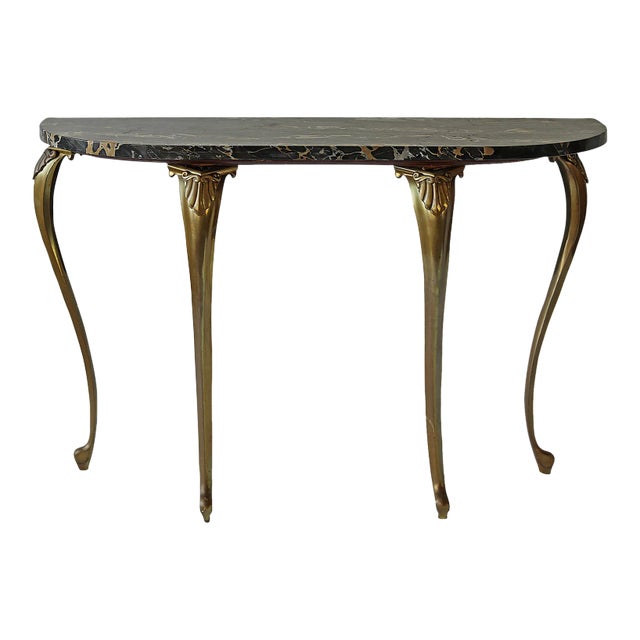 Vintage, Italian console table. Black marble top and gold toned metal tapered legs. * The marble can be removed from the...