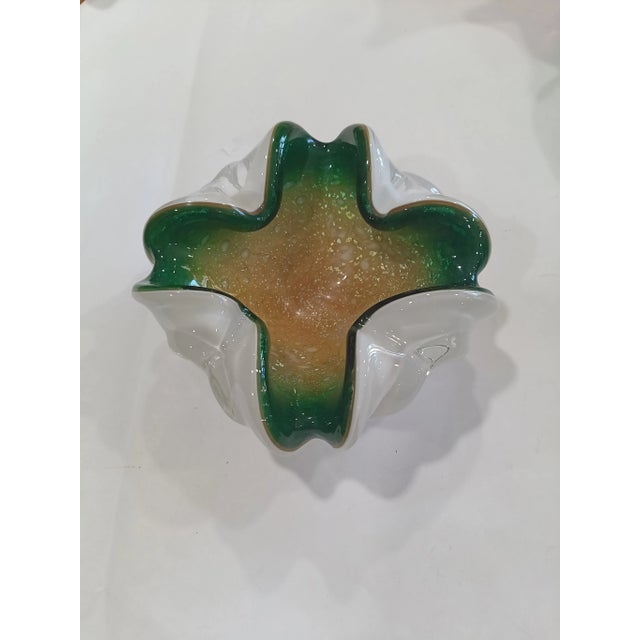 This vibrant mid-century glass ashtray is attributed to Murano based on its complex triple sommerso construction and...