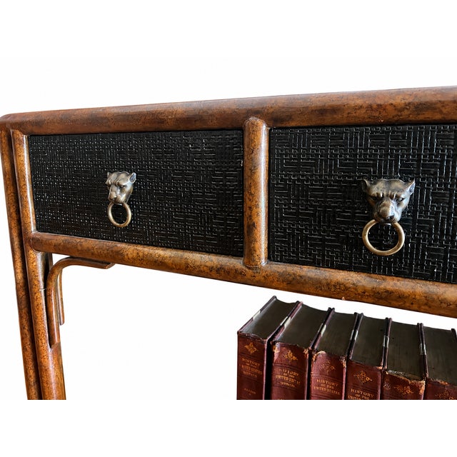 This piece is a vintage Kreiss faux bamboo and leather-top console table with "panther ring" pulls, typically dating back...