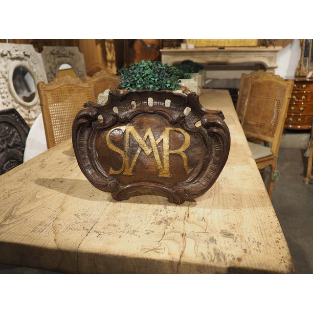 Hand-carved in oak and dating to the 1700s, this French altar plaque features a painted monogram that reads “AMSR”. The...