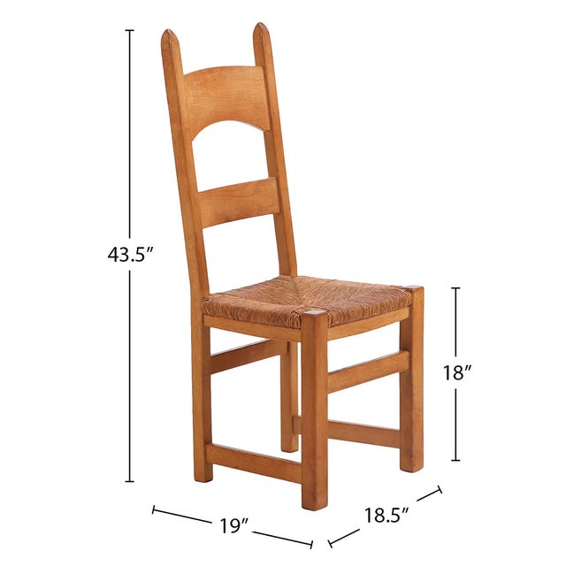 Set of six French oak dining chairs dating to circa 1950. Tall ladder backs with gently shaped rails are paired with...