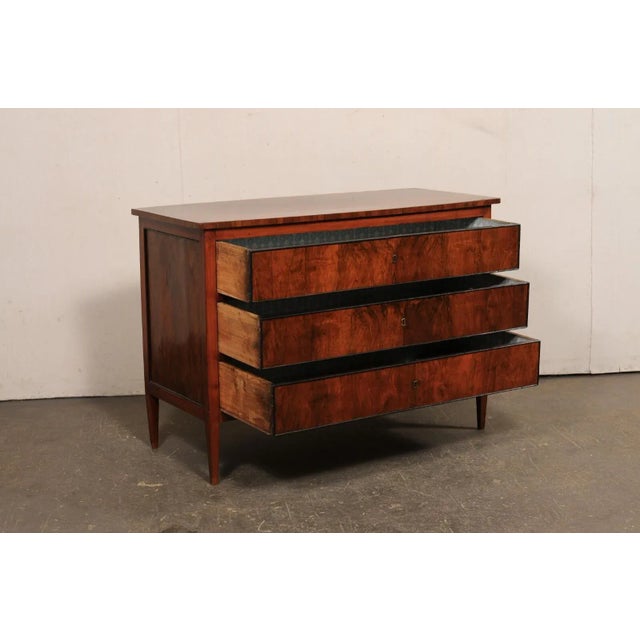 An Italian wooden three drawer chest from the early 19th century. This antique chest from Italy has a rectangular-shaped...