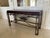 A beautifully crafted console table featuring a sturdy wrought iron base paired with an inlaid wood top, blending strength...