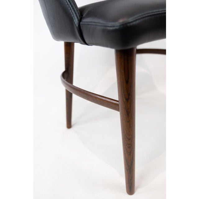 Easy chair upholstered with black leather and legs of rosewood designed by Chr. Linneberg from the 1960s.The chair is in...
