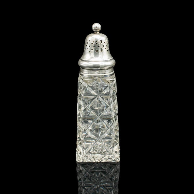 This is a vintage sugar shaker. An English, cut glass and sterling silver caster by James Deakin & Son, dating to the...