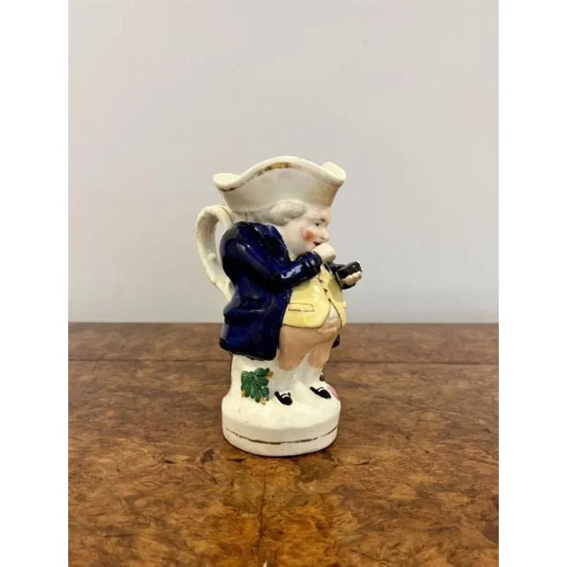 Quality antique Victorian Staffordshire toby jug of Mr Snuff having a quality in blue, white, pink, green and black...