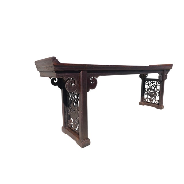 This mid 18th century antique altar table features an exceptionally long, narrow profile with a rich finish highlighting a...
