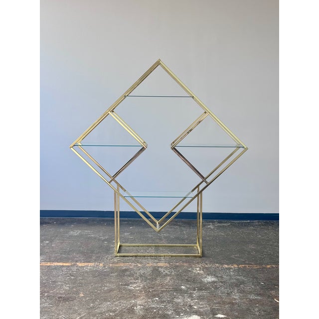 Fabulous vintage diamond brass and glass etagere in the style of Milo Baughman. Four floating glass shelves. All the drama...