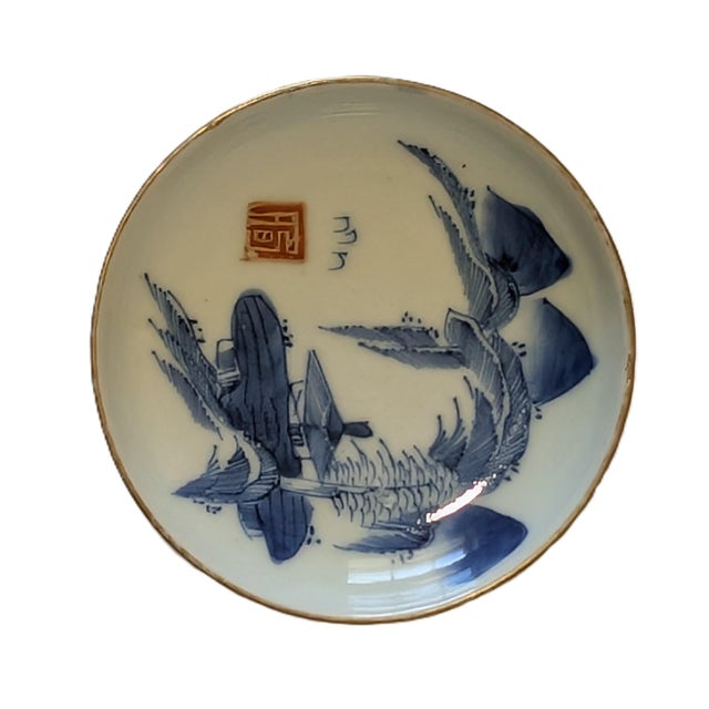 This beautiful blue-and-white palette features scenery in the front and a floral pattern in the back. It dates to the...