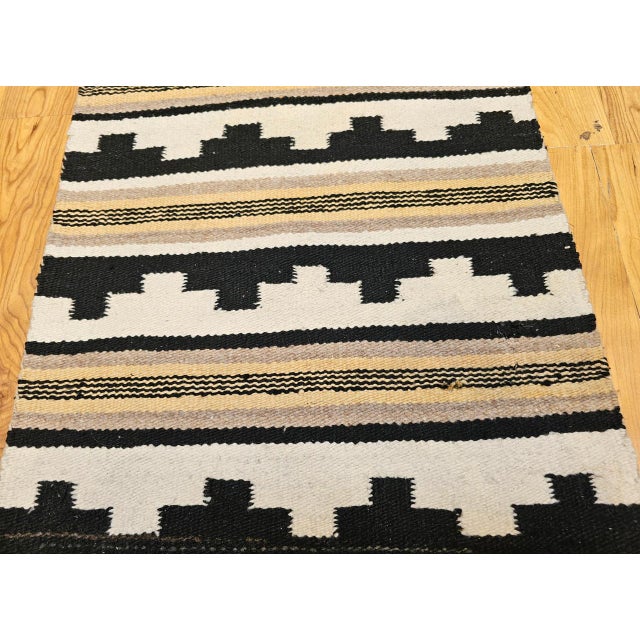 This beautiful vintage Navajo rug from the Southwestern United States captures the spirit and colors of the iconic desert...