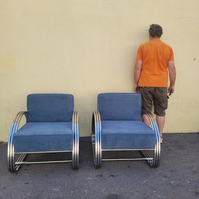 Pair of large chrome armchairs with rounded tubing, in the Art Deco style; based on the Hudson model by designer Ralph...