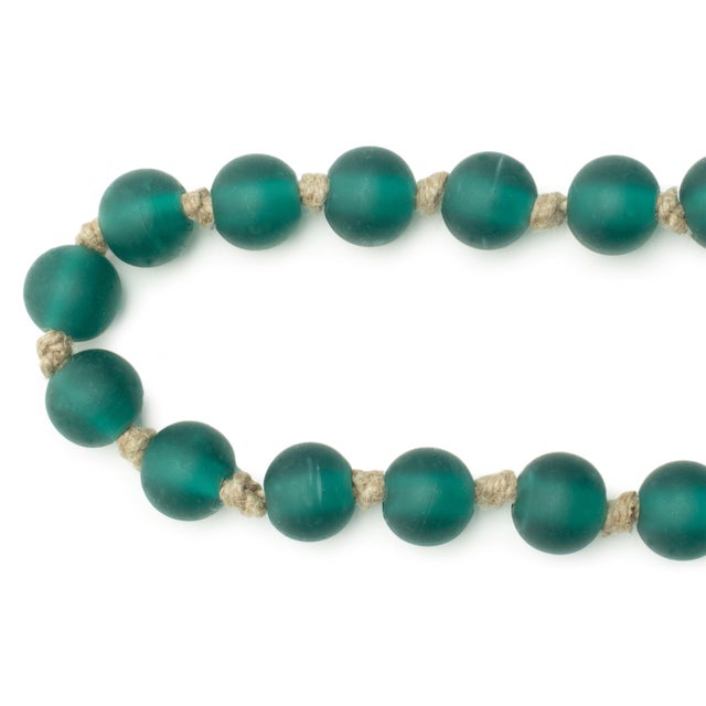 Add a touch of elegance to your holiday displays with the Frosted Glass Bead Garland. Featuring a wintry green and beige...