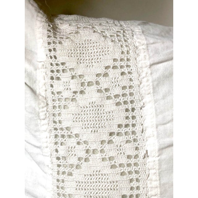 Soft white cotton pillow sham with a hand made band of lace near the top edge and two button closure on back.