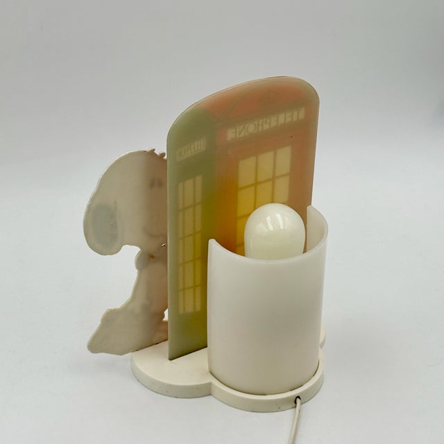 Original 1980s Snoopy table lamp produced by Nuova Linea Zero, Italy. This playful and highly decorative lamp features the...