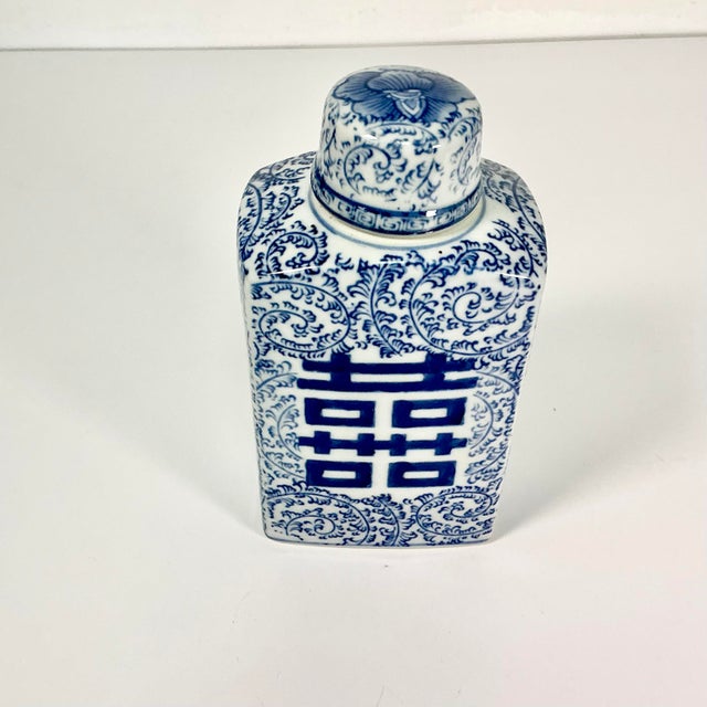 This Chinoiserie Square Ginger Jar features a hand-painted Happiness symbol on two sides. It also has an overall swirled...
