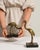This mid 20th century sculpture from France is finished in brass, worked in marble. Its form follows honest, well-...