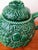 Green Fruit Majolica Teapot. This charming teapot features a lovely green majolica color with a shiny glaze. The design...
