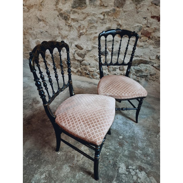 This pair of antique French chairs dates from the Napoleon III period (mid to late 1800s). Crafted in carved and ebonized...