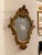 This is a beautiful vintage Italian Florentine-style giltwood mirror, featuring an ornate carved frame with a graceful,...