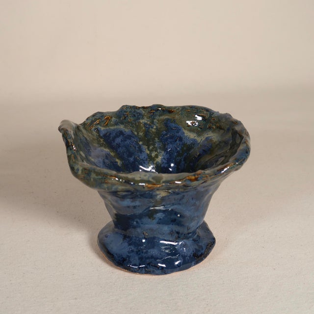 A one-of-a-kind handmade studio pottery vessel featuring an expressive, organic silhouette with a flared, petal-like rim...