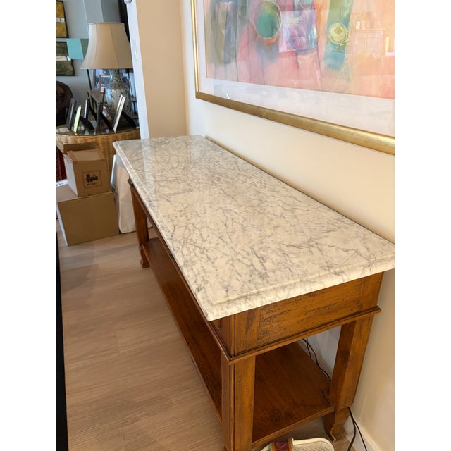Elegant vintage wood console/ buffet featuring a beautifully veined marble top and classic refined proportions. The richly...
