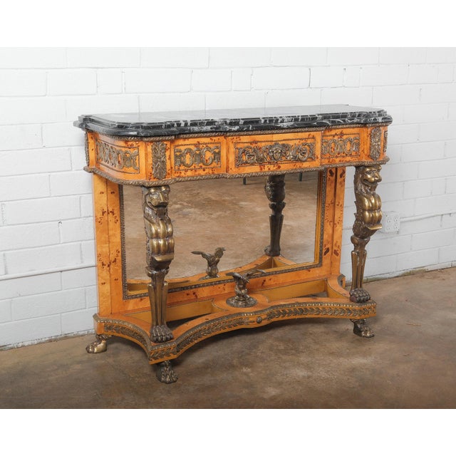 An extraordinary 19th-century neoclassical console table crafted in the Empire Revival style, featuring dramatic gilt...
