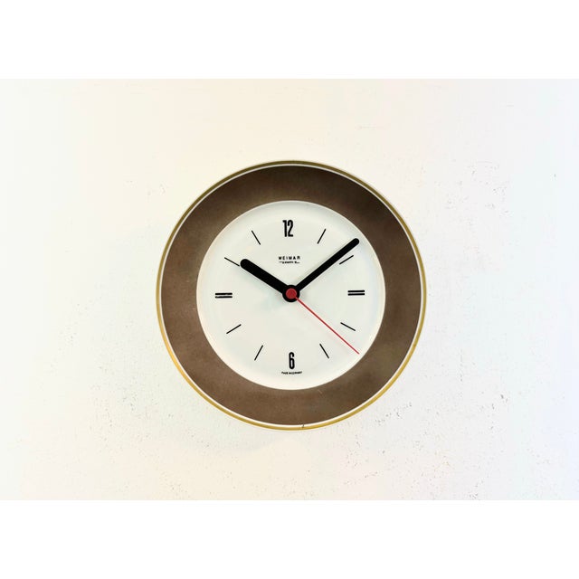 Vintage Industrial wall clock produced by Weimar Electric in former East Germany during the 1970s. It features a porcelain...