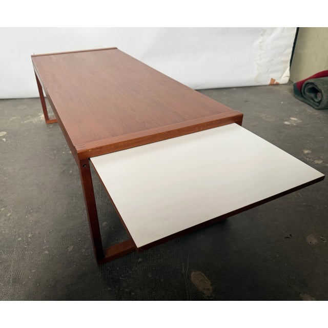 Teak coffee table,with formica extensions hidden under the top, meant for placing cold drinks etc. Can be extended maximum...