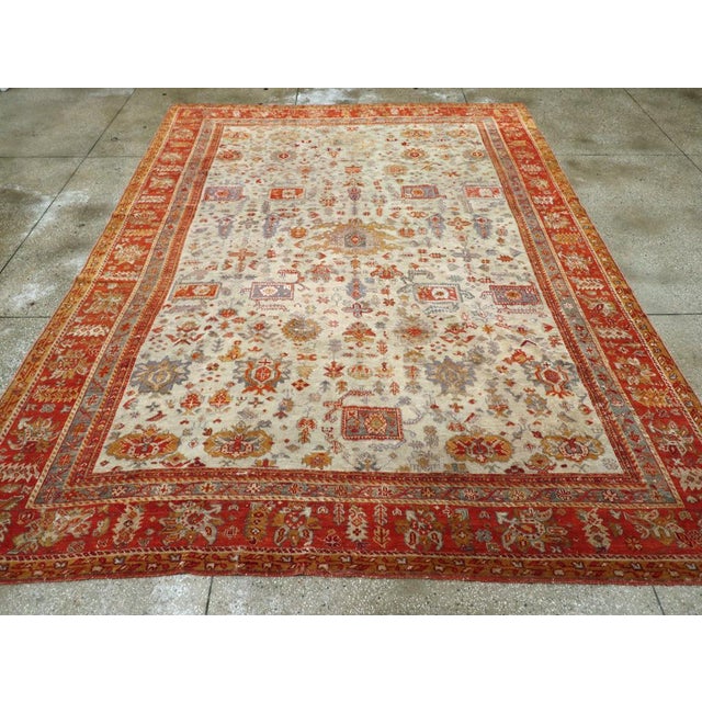 An antique Turkish Oushak room size carpet handmade during the Early 20th century. Measures: 9' 9" x 13' 0"