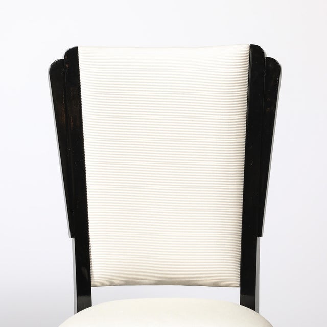 An exceptional set of six Art Deco dining chairs, originating from the United States, circa 1935, embody the bold geometry...