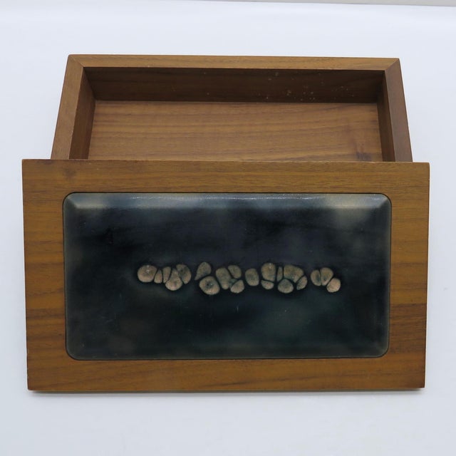 Handsome carved walnut box with enamel over copper panel and wood lift-off lid. The inset enamel plate has been finished...