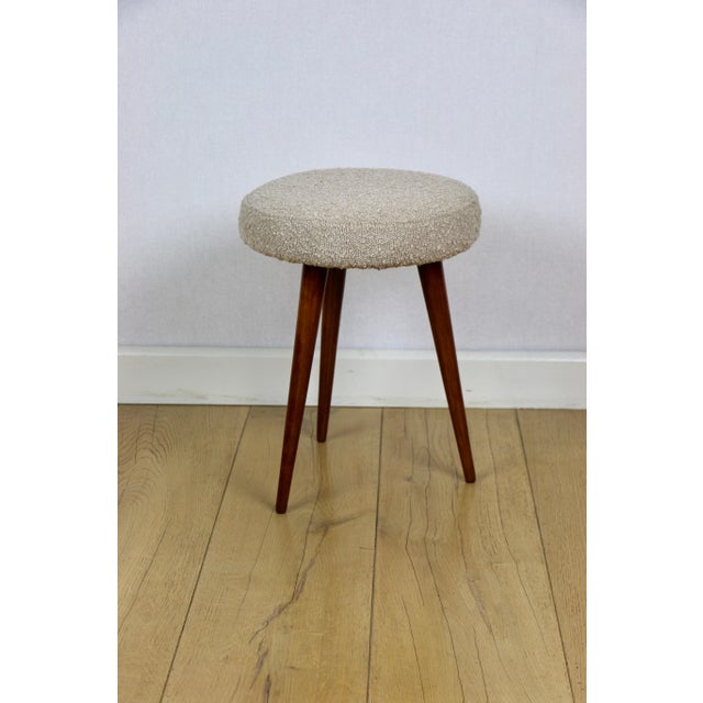 Round beige stool made of boucle fabric. Vintage PRL stool manufactured in the 1970s. Fully restored, upholstered in a...